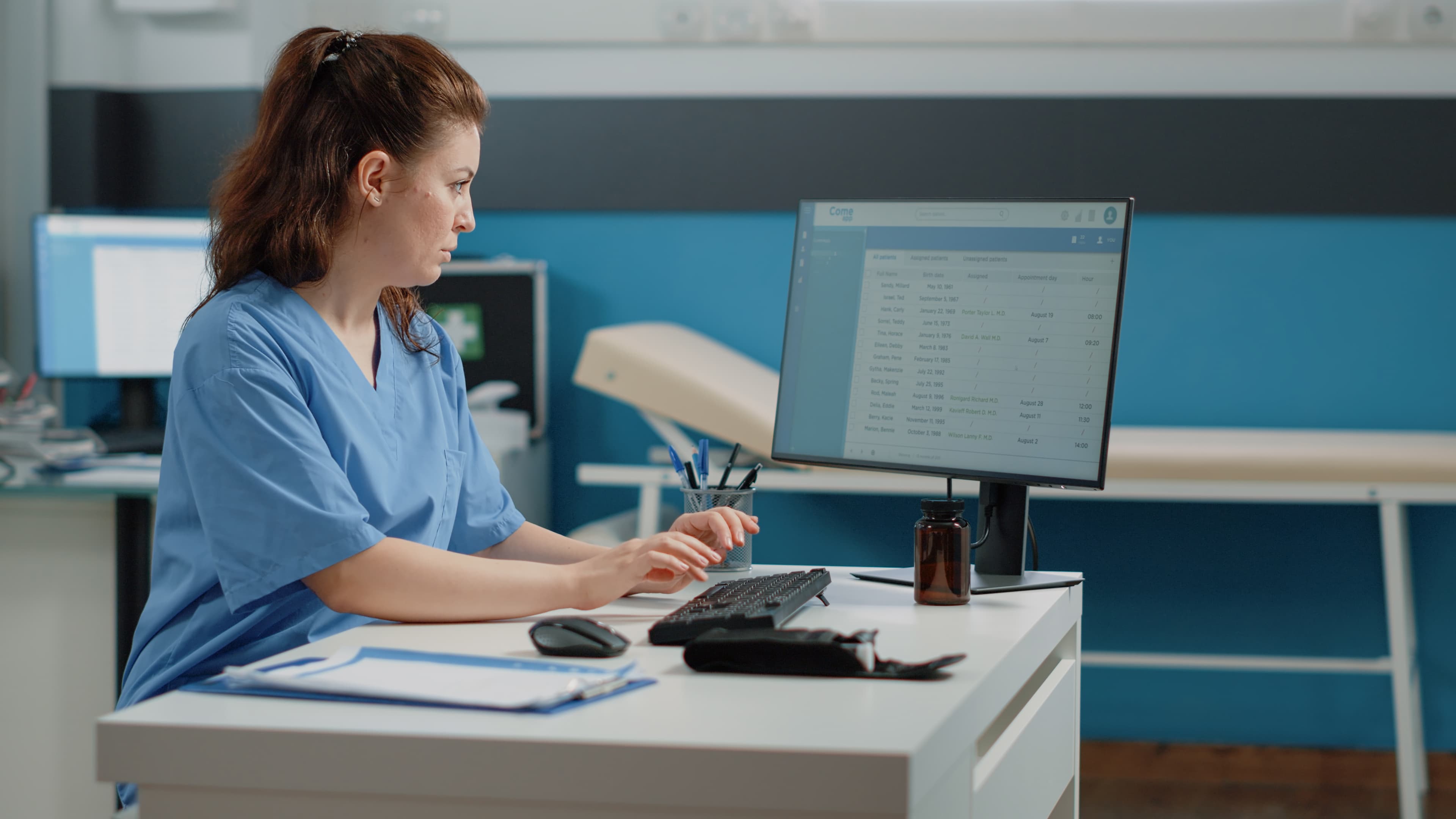 Nurse managing patient records and scheduling on-screen